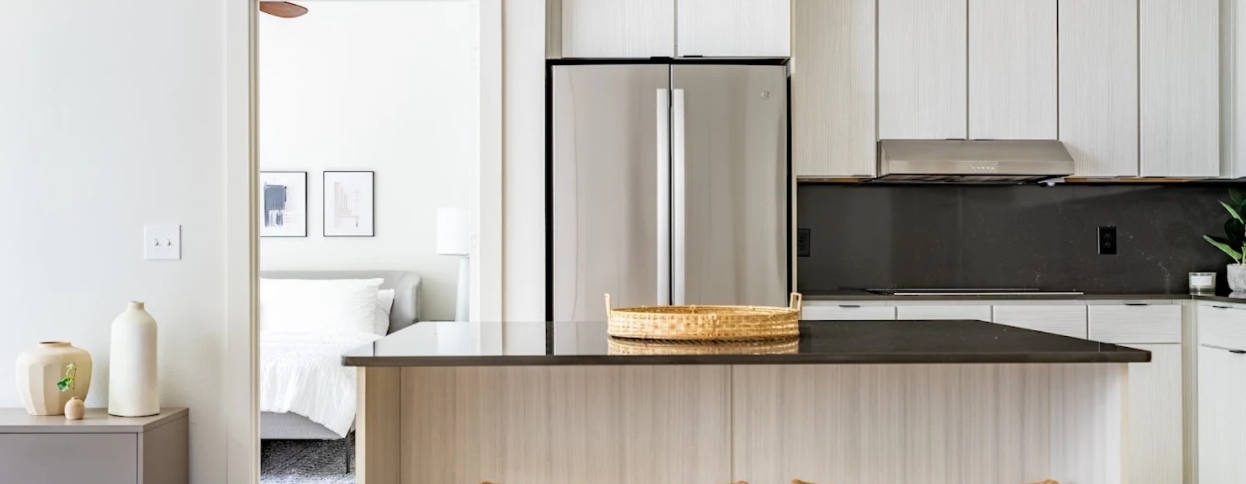 a kitchen with a table and a refrigerator