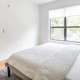 a bedroom with a bed and a lamp