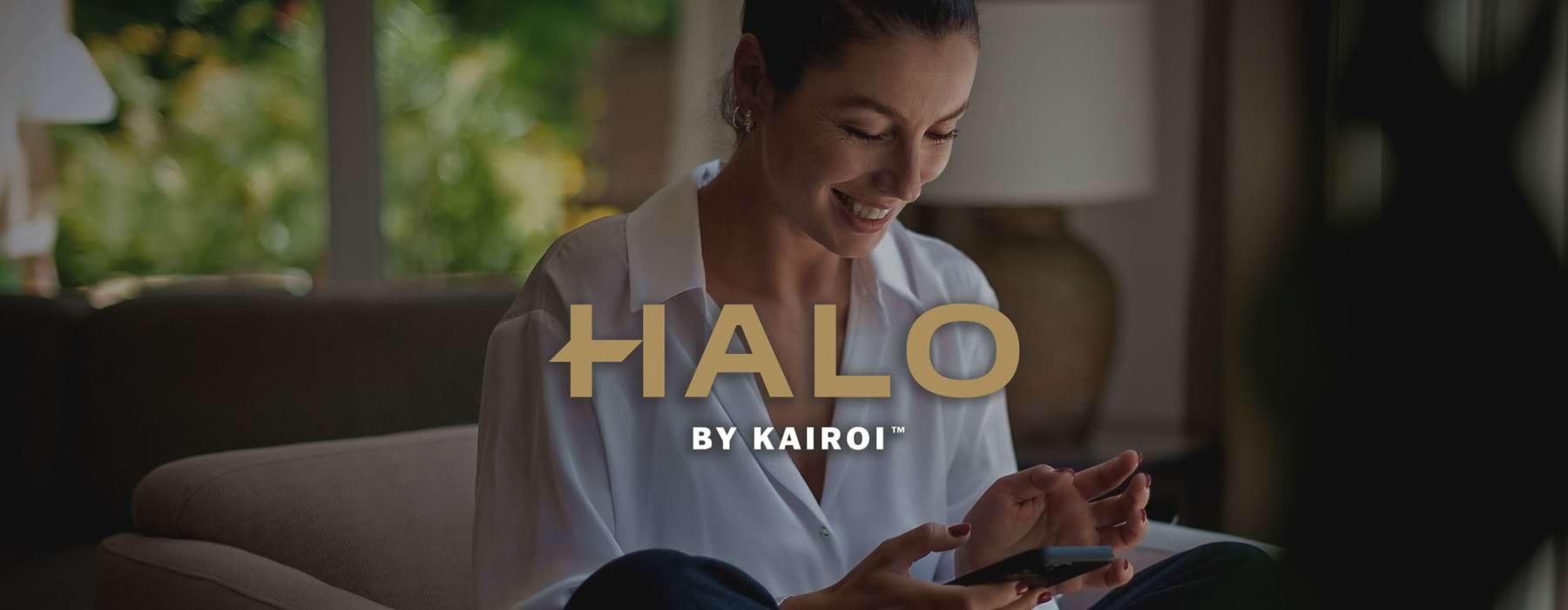 a woman smiling and interacting with her device